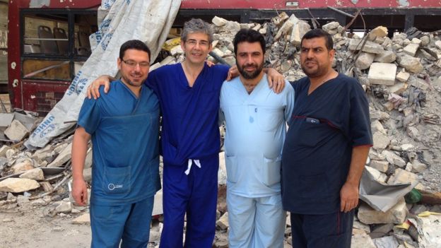 Image from BBC: David Nott with others undertaking medical work in war zone